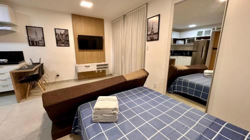 a small room with a bed and a television at AP1607 ar cond piscina academia coworking etc in Juiz de Fora
