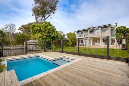 a home with a swimming pool and a fence at 7th Heaven - Bluff Hill, Napier in Napier
