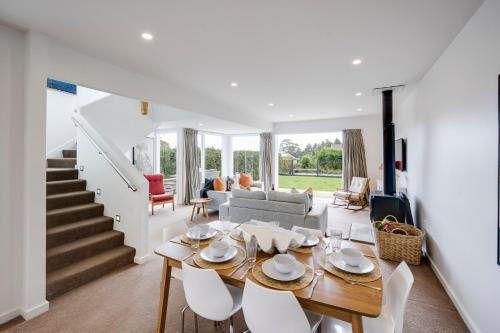 a living room with a table and chairs and a couch at 7th Heaven - Bluff Hill, Napier in Napier