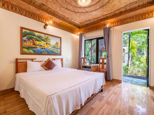 a bedroom with a bed and a large window at Trang An Lighthouse Homestay in Ninh Binh