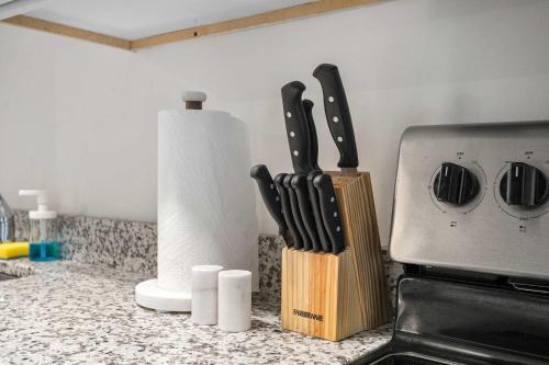 a kitchen counter with a knife block and a stove at CozySuites Stunning 1BR in Downtown Pitts #12 in Pittsburgh