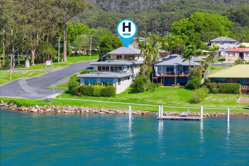 an aerial view of a house next to a body of water at Slipways in Laurieton