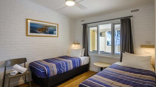 a hotel room with two beds and a window at Stay Rottnest in Rottnest Island