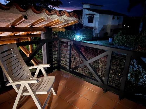 a chair sitting on a porch at night at Casa Panaca Portal 12 in Quimbaya