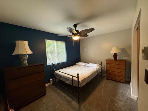a bedroom with a bed and a ceiling fan at Luxury Mountain Villa - 3 bedroom, hot-tub, fire-pit in Hunter