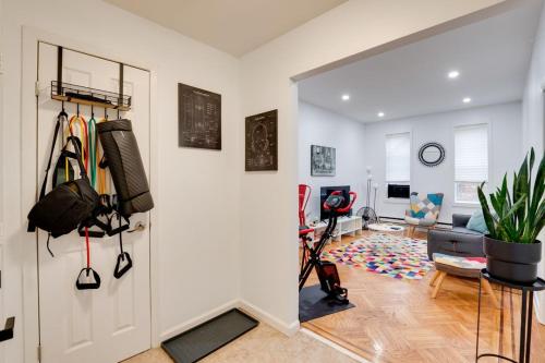a room with a white door and a living room at Cozy Condo Jersey City in Jersey City