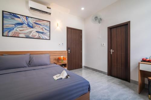 a bedroom with a bed with a book on it at Binh An Motel in Da Nang