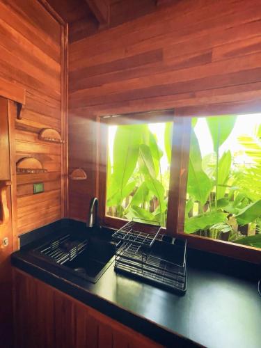 a kitchen with a fish tank on the counter at Tropical Private Bungalow Oasis Kemuning Bukit in Ungasan