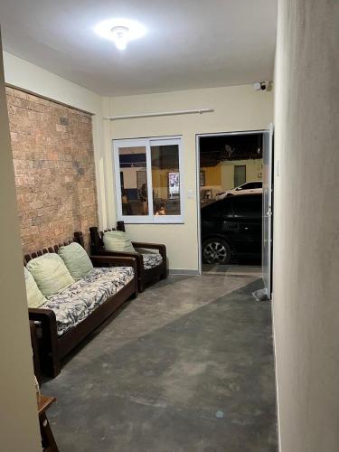 a living room with a couch and a car at Hospedaria Casa da Lia in Mucugê