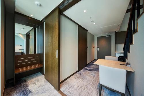 an office with a door leading into a room at Hotel HLB in Busan