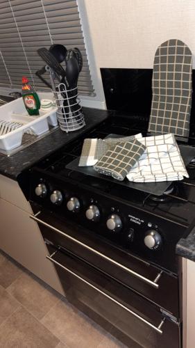 a kitchen with a stove top oven in a kitchen at Bills place in Heysham