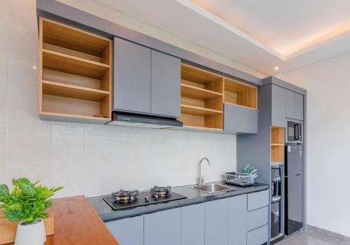 a kitchen with white cabinets and a sink at Winar Villa Canggu in Munggu