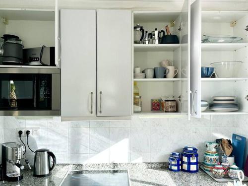 a kitchen with white cabinets and a counter top at Casa Tropicana Family & Golf in Sitio de Calahonda
