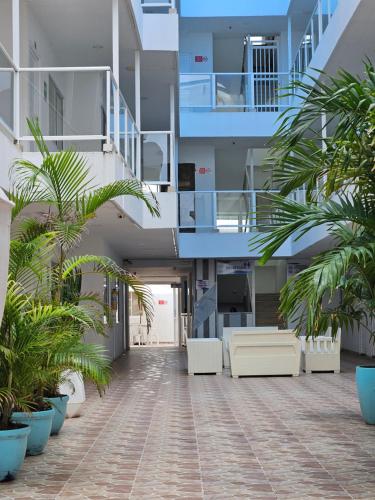 an empty lobby of an apartment building with palm trees at Caribbean Island Hotel Piso 2 in San Andrés