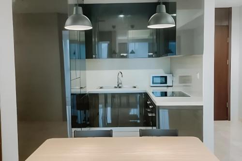 a kitchen with a table with chairs and a sink at Sellaracz Residance 014 in Tegaldanas