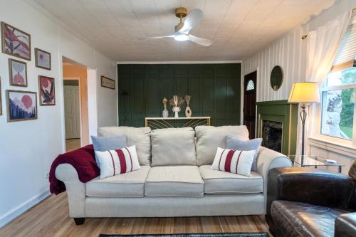 a living room with a couch and a green wall at Fern Landing - Peaceful, spacious, modern, firepit in Chattanooga
