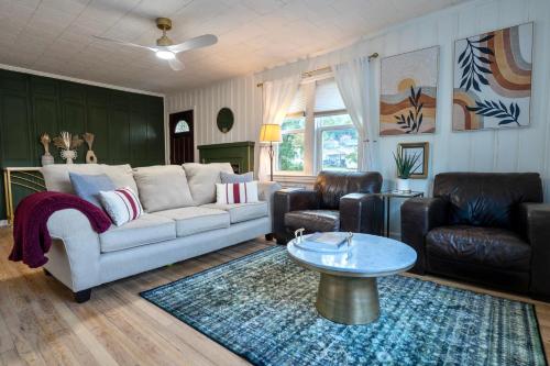 a living room with a couch and a table at Fern Landing - Peaceful, spacious, modern, firepit in Chattanooga