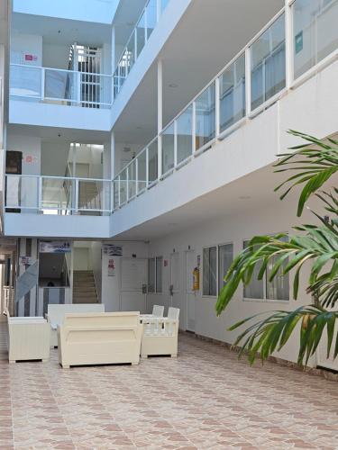 arium of a building with a staircase and a lobby at Caribbean Island Hotel Piso 2 in San Andrés