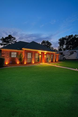 a house with a lawn in front of it at Private Pool Paradise in Prattville