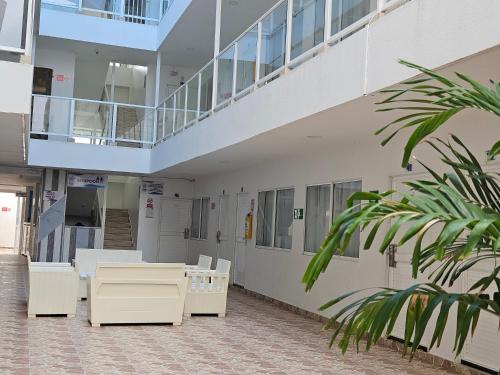 a hallway of a hospital with tables and chairs at Caribbean Island Hotel Piso 2 in San Andrés