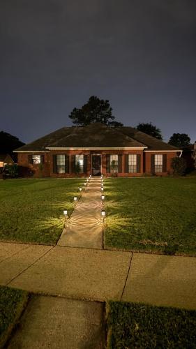 a house with a sidewalk in front of a house at Private Pool Paradise in Prattville