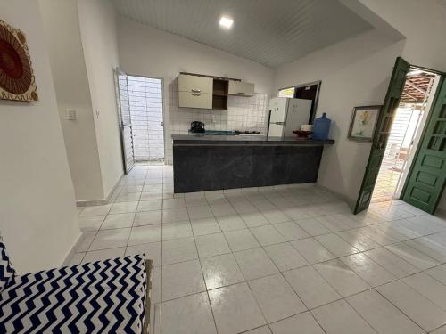 a large room with a kitchen with a counter top at Casa Com Piscina em Itamaracá in Itamaracá