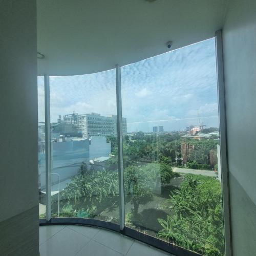 a view of a city from a window in a building at KHÁCH SẠN MlLAN in Dĩ An