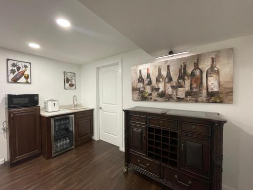 a kitchen with a painting of wine bottles on the wall at Lake Michigan Retreat in Racine