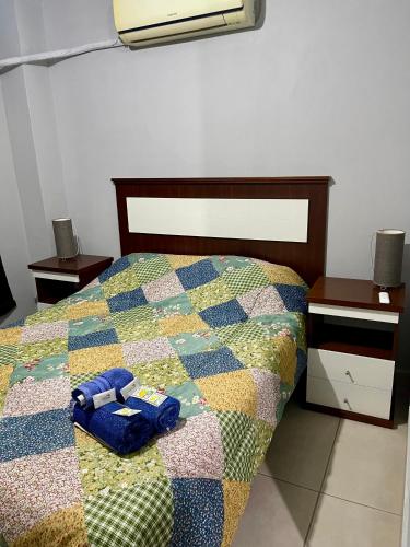 a bedroom with a bed with a quilt on it at 4-Espectacular departamento centrico in Morón