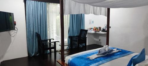 a bedroom with a bed with an animal laying on it at Carpe Diem Villas & Resort in Puerto Princesa City