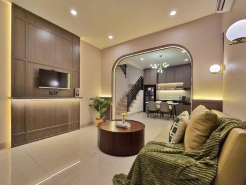 a living room with a couch and a table at LuMen By SanLiving - 3BR - NICE Expo - Free Parking in Rawalumpang