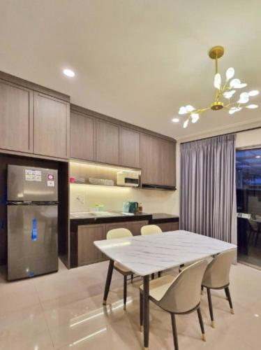 a kitchen with a table and chairs in a kitchen at LuMen By SanLiving - 3BR - NICE Expo - Free Parking in Rawalumpang