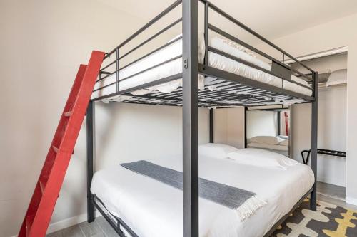 a couple of bunk beds in a room at Desert Picasso! Pool, Spa, Games, Mountain Views in Desert Hot Springs