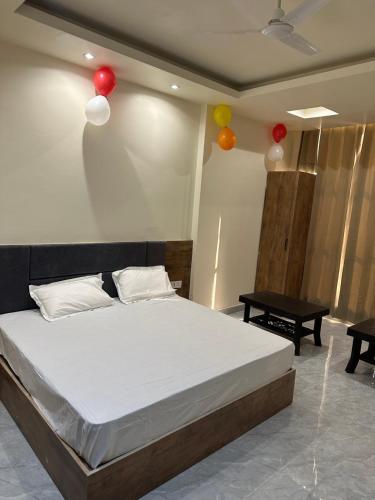 a bedroom with a bed with balloons on the wall at DREAM Inn HOTEL in Alwar