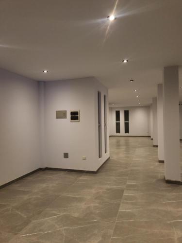 an empty room with white walls and a tile floor at Hotel Alba in Ica