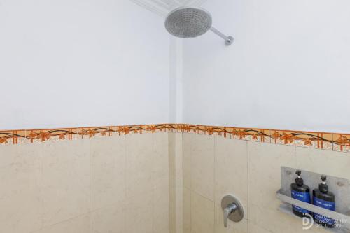 a shower with a shower head in a bathroom at Tinggian Hill Retreat in Nusa Penida