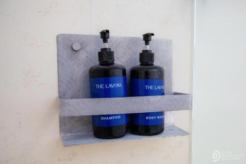 two bottles on a shelf on a wall at Tinggian Hill Retreat in Nusa Penida