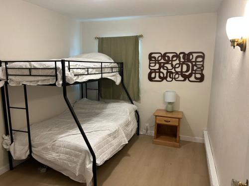 a bedroom with two bunk beds and a table at Cottages by Storybook Park in Burley