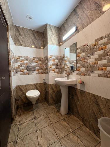 a bathroom with a sink and a toilet at Hotel JB Residency Zirakpur Chandigarh # Large Rooms # Balcony Rooms # Top Rated in Zirakpur