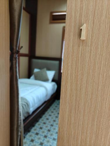a door leading to a bedroom with a bed at Qion's Villa in Cibogo