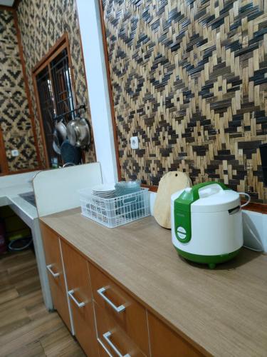 a kitchen counter with a toaster on top of it at Qion's Villa in Cibogo