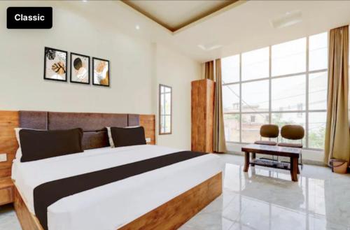 a bedroom with a large bed and a window at DREAM Inn HOTEL in Alwar