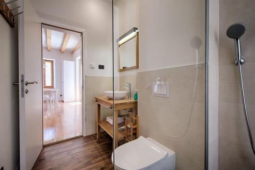 a bathroom with a toilet and a sink and a shower at Apartments Villa Glorija in Komiža