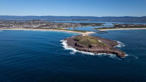 an aerial view of an island in the ocean at Lake Illawarra Family Escape in Lake Illawarra