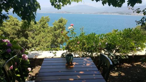 a wooden table with a view of the ocean at Ece Hotel Sovalye Island in Fethiye