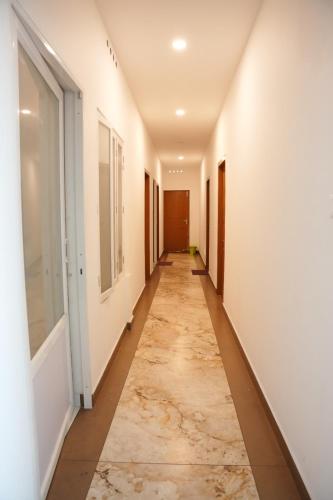 a corridor of an empty room with a long hallway at Aira inn&Suites in Cochin