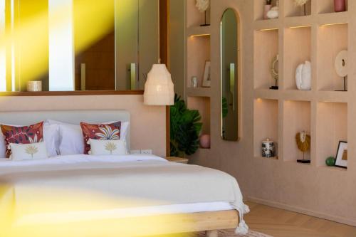 a bedroom with a white bed and some shelves at Rosa Del Mar Seaview Villa with gym in Ban Nong Chaeng