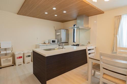 a kitchen with a sink and a counter at Tropical Beach Vacation House in Ginowan