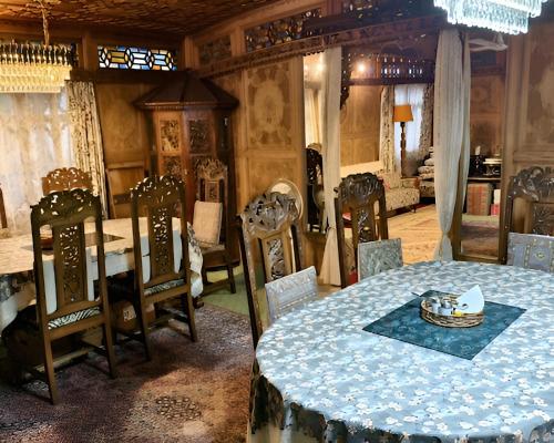 a dining room with a table and chairs at The Royal hareem group of houseboats in Srinagar
