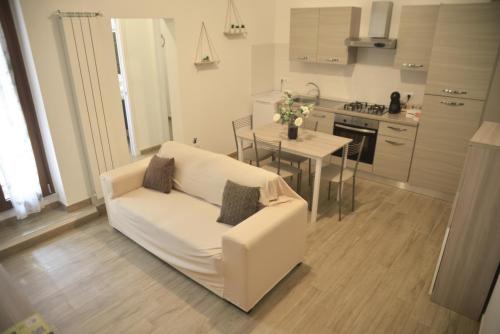 un salon avec un canapé blanc et une table dans l'établissement TOI Apartments, à Brindisi